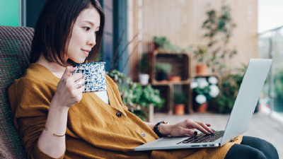woman with computer and coffee