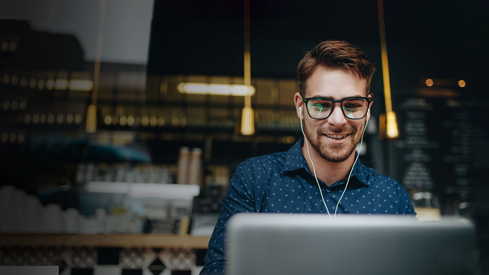 man with computer in coffee shop